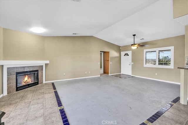 63357 Uranium Rd, Joshua Tree, CA 92252 - unfurnished living room with baseboards, a ceiling fan, lofted ceiling, a fireplace, and tile patterned flooring