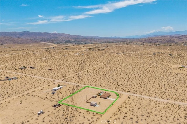 63357 Uranium Rd, Joshua Tree, CA 92252 - overview of rural landscape featuring property parcel outlined, a mountainous background, and a desert landscape