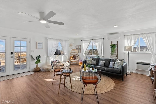 55436 Cone Blvd, Landers, CA 92285 - living area with an AC wall unit, french doors, wood finished floors, a ceiling fan, and recessed lighting