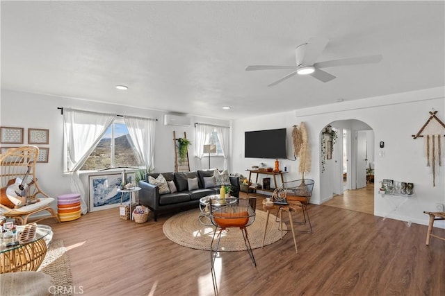 55436 Cone Blvd, Landers, CA 92285 - living room with an AC wall unit, arched walkways, wood finished floors, a ceiling fan, and recessed lighting