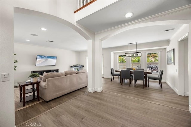 20660 Calle Feliz, Yorba Linda, CA 92886 - living area with arched walkways, wood finished floors, crown molding, recessed lighting, and baseboards
