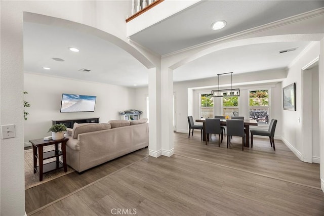 20660 Calle Feliz, Yorba Linda, CA 92886 - living room with arched walkways, wood finished floors, recessed lighting, and ornamental molding
