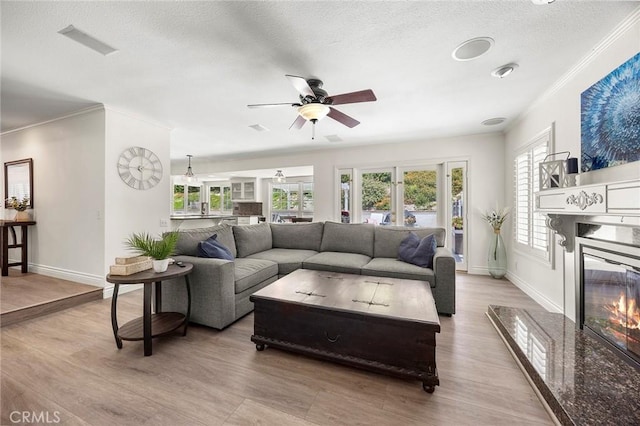 20660 Calle Feliz, Yorba Linda, CA 92886 - living room featuring healthy amount of natural light, a ceiling fan, ornamental molding, baseboards, and a textured ceiling