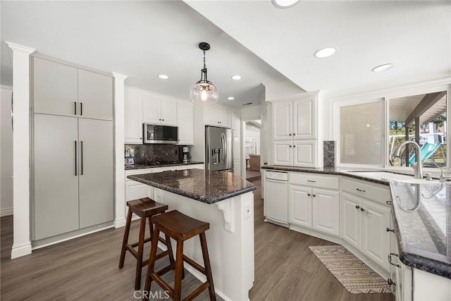 20660 Calle Feliz, Yorba Linda, CA 92886 - kitchen featuring stainless steel appliances, a sink, dark wood finished floors, tasteful backsplash, and white cabinets