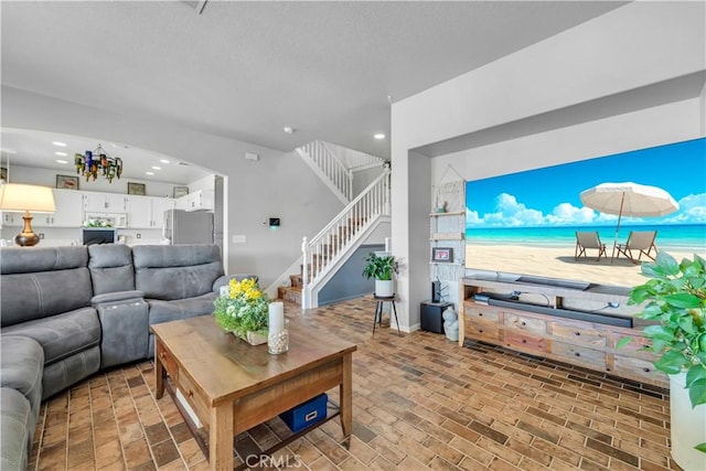 2832 Owens Way, Rosamond, CA 93560 - living room with stairs, recessed lighting, brick patterned flooring, arched walkways, and baseboards