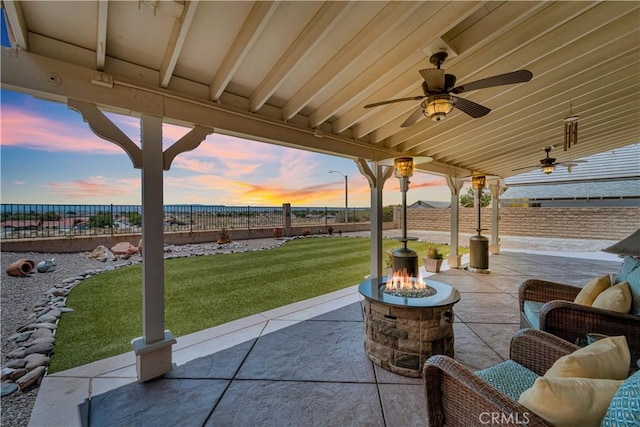 2832 Owens Way, Rosamond, CA 93560 - patio terrace at dusk featuring a fire pit, a patio, and a ceiling fan