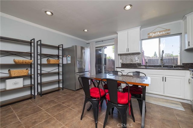 8568 Century Blvd Unit B, Paramount, CA 90723 - kitchen with stainless steel refrigerator with ice dispenser, ornamental molding, dark countertops, white cabinetry, and a sink