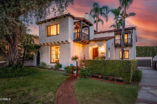 1338 Carmen Dr, Glendale, CA 91207 - mediterranean / spanish house with a balcony, a gate, a tiled roof, and stucco siding