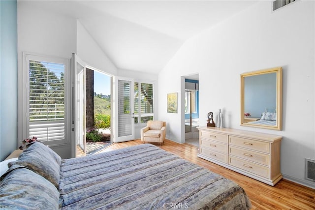 48 Siena, Laguna Niguel, CA 92677 - bedroom featuring access to outside, vaulted ceiling, multiple windows, and light wood-style flooring