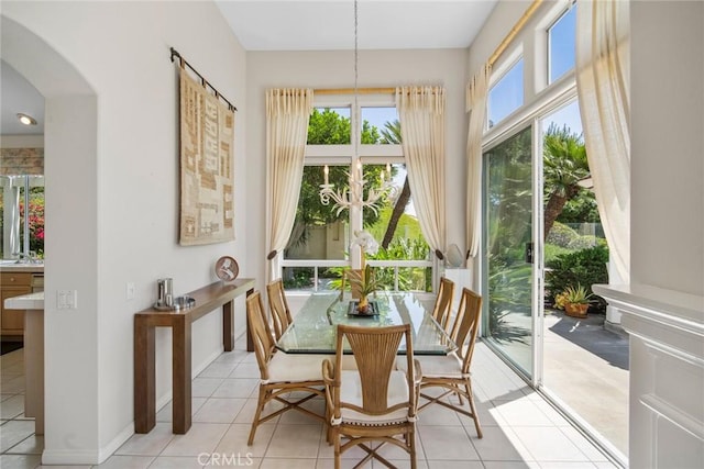 48 Siena, Laguna Niguel, CA 92677 - dining room featuring arched walkways, light tile patterned floors, and baseboards