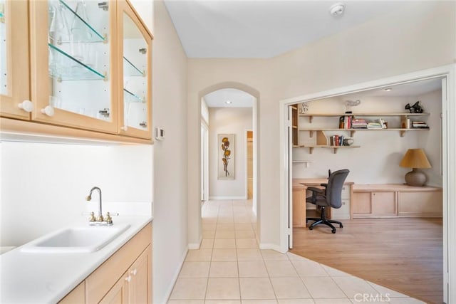 48 Siena, Laguna Niguel, CA 92677 - bar area featuring a sink, light tile patterned flooring, arched walkways, and baseboards