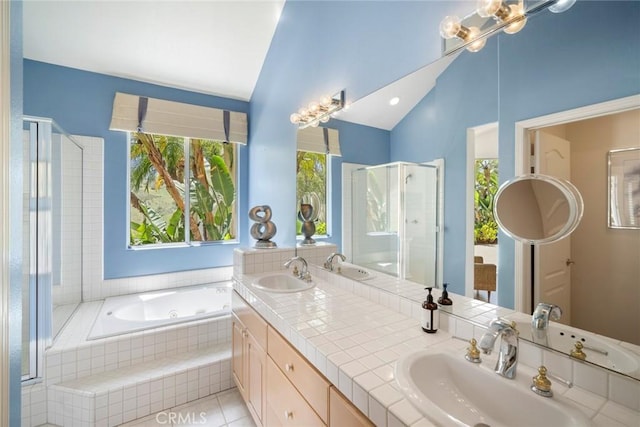 48 Siena, Laguna Niguel, CA 92677 - bathroom featuring vaulted ceiling, healthy amount of natural light, a garden tub, double vanity, and a stall shower