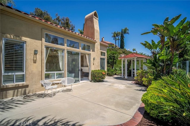 48 Siena, Laguna Niguel, CA 92677 - rear view of property featuring a chimney, a patio area, stucco siding, and a gazebo