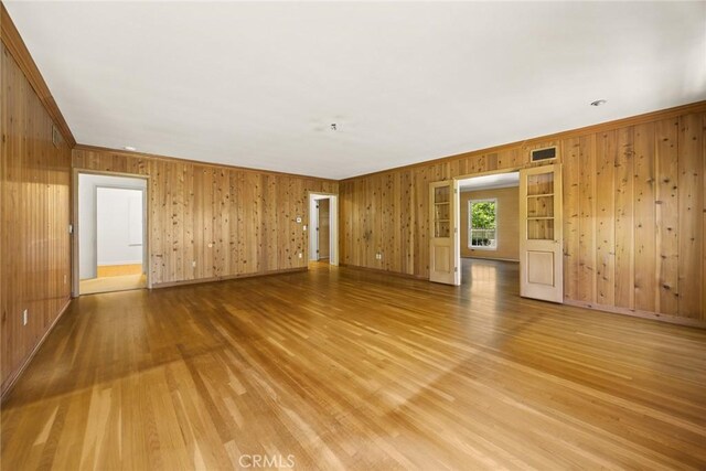 85 S San Rafael Ave, Pasadena, CA 91105 - spare room featuring wood walls, light wood-style floors, baseboards, and ornamental molding