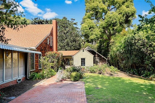 85 S San Rafael Ave, Pasadena, CA 91105 - view of front of home with a front lawn, a chimney, and roof with shingles