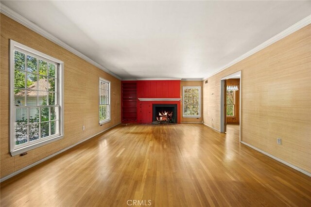 85 S San Rafael Ave, Pasadena, CA 91105 - unfurnished living room with light wood-style flooring, ornamental molding, a lit fireplace, and baseboards