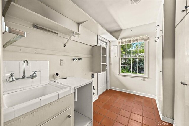 85 S San Rafael Ave, Pasadena, CA 91105 - laundry area featuring dark tile patterned flooring and baseboards