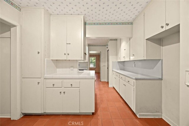 85 S San Rafael Ave, Pasadena, CA 91105 - kitchen featuring tile countertops, light tile patterned floors, baseboards, wallpapered walls, and white cabinets