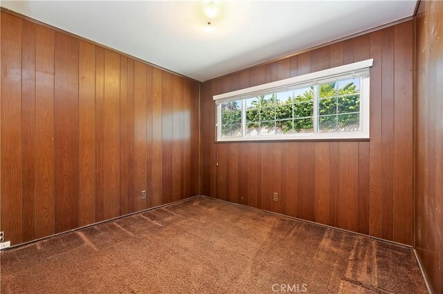 1825 Leola St, Lomita, CA 90717 - empty room featuring carpet floors and wood walls
