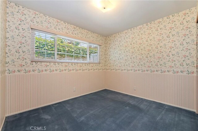 1825 Leola St, Lomita, CA 90717 - empty room featuring wallpapered walls, wainscoting, and dark colored carpet