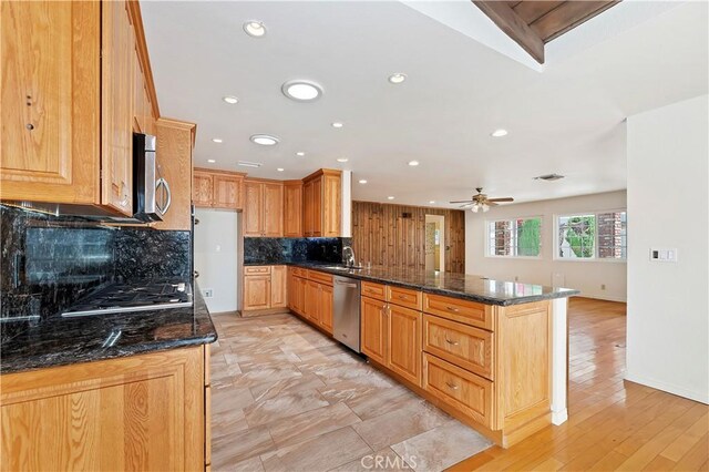 1825 Leola St, Lomita, CA 90717 - kitchen with appliances with stainless steel finishes, a peninsula, a sink, tasteful backsplash, and a ceiling fan