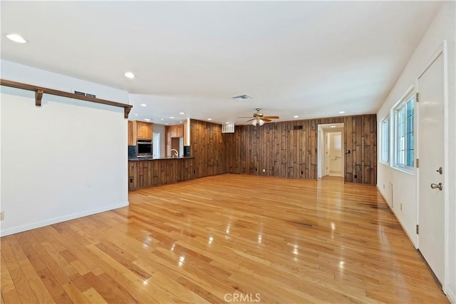1825 Leola St, Lomita, CA 90717 - unfurnished living room featuring recessed lighting, light wood finished floors, ceiling fan, and wood walls