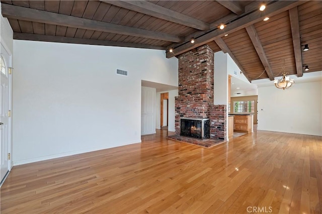 1825 Leola St, Lomita, CA 90717 - unfurnished living room with track lighting, wooden ceiling with exposed beams, light wood finished floors, a fireplace, and baseboards