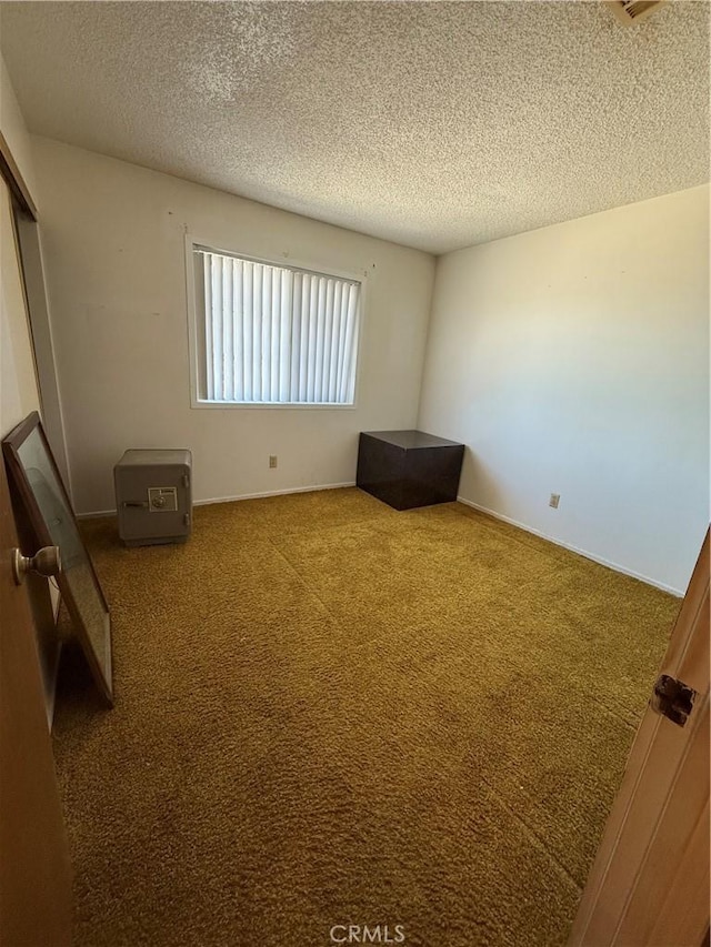 72400 El Paseo Dr Unit 29, Palms, CA 92277 - unfurnished bedroom featuring a textured ceiling, carpet floors, and a closet