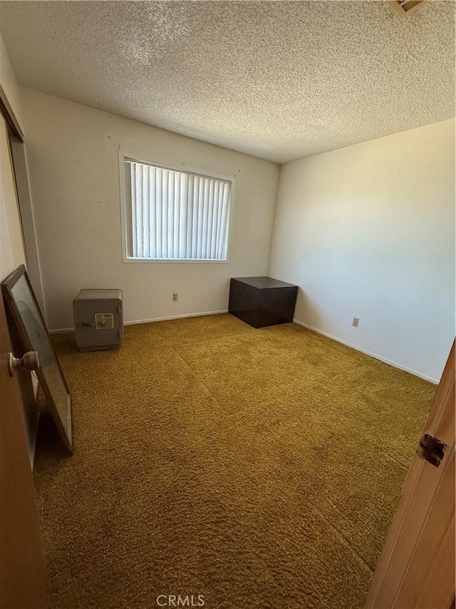 72400 El Paseo Dr Unit 29, Palms, CA 92277 - unfurnished bedroom with a textured ceiling, carpet, and a closet