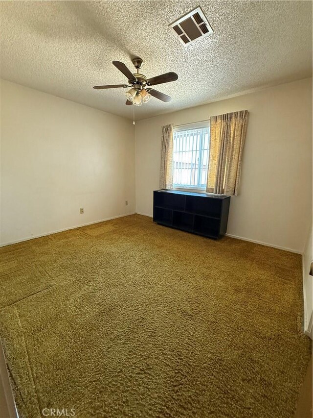 72400 El Paseo Dr Unit 29, Palms, CA 92277 - empty room featuring carpet floors, ceiling fan, and a textured ceiling