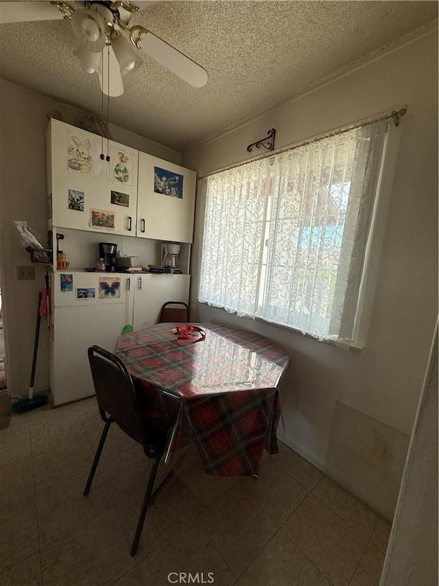 72400 El Paseo Dr Unit 29, Palms, CA 92277 - dining room featuring a ceiling fan, a textured ceiling, and light tile patterned floors