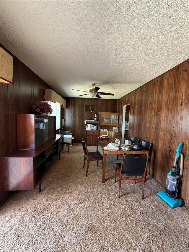 72400 El Paseo Dr Unit 29, Palms, CA 92277 - carpeted dining area with wooden walls, a textured ceiling, and ceiling fan