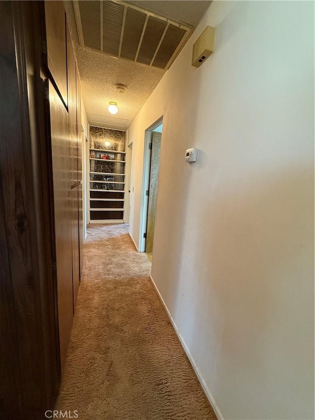 72400 El Paseo Dr Unit 29, Palms, CA 92277 - hallway featuring light carpet and baseboards