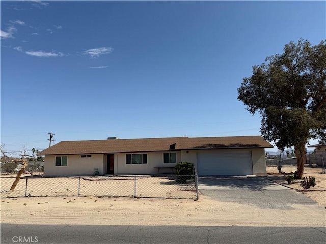 72400 El Paseo Dr Unit 29, Palms, CA 92277 - ranch-style house with an attached garage, driveway, a fenced front yard, and stucco siding