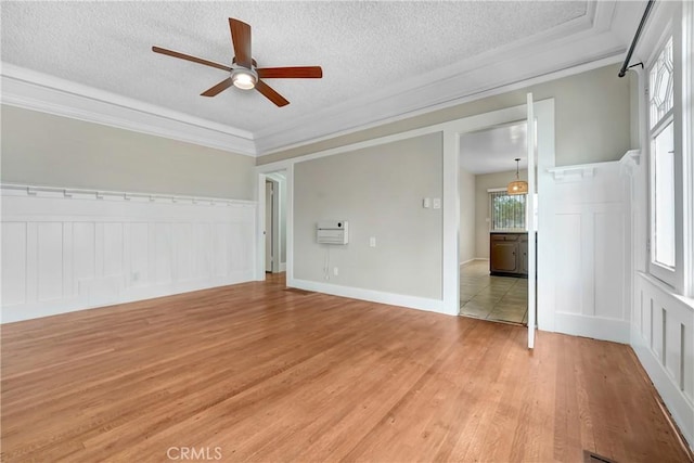 142 S Ardmore Ave, Los Angeles, CA 90004 - spare room featuring a ceiling fan, light wood finished floors, ornamental molding, a textured ceiling, and a decorative wall