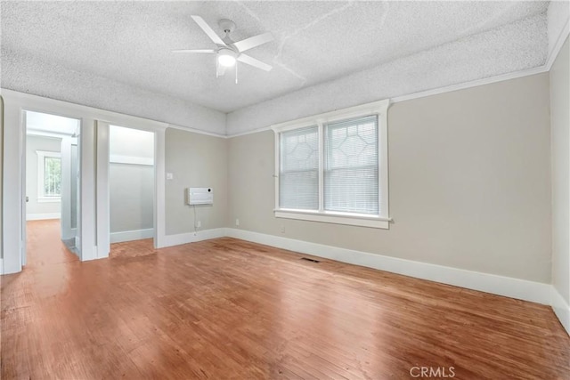 142 S Ardmore Ave, Los Angeles, CA 90004 - spare room with a textured ceiling, wood finished floors, a ceiling fan, baseboards, and heating unit
