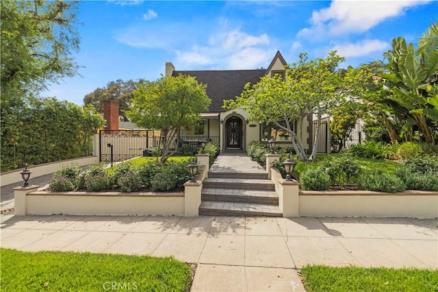 645 Glenmore Blvd, Glendale, CA 91206 - english style home with a fenced front yard, stucco siding, and roof with shingles