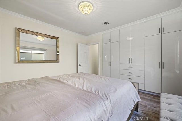 645 Glenmore Blvd, Glendale, CA 91206 - bedroom with dark wood-type flooring, crown molding, and a closet