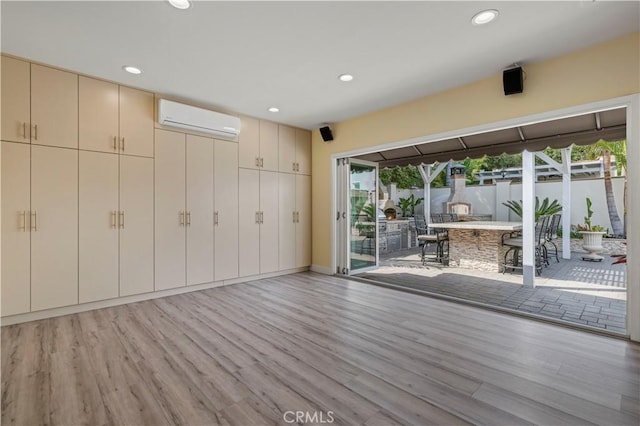 645 Glenmore Blvd, Glendale, CA 91206 - unfurnished living room featuring an AC wall unit, light wood finished floors, and recessed lighting