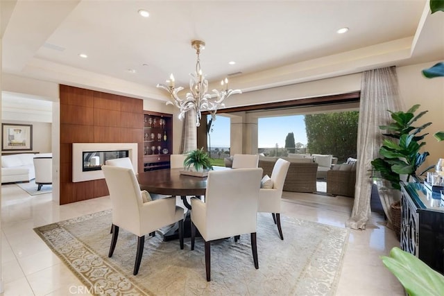 32661 Caribbean Dr, Dana Point, CA 92629 - dining room with a tray ceiling, a chandelier, a fireplace, recessed lighting, and light tile patterned floors