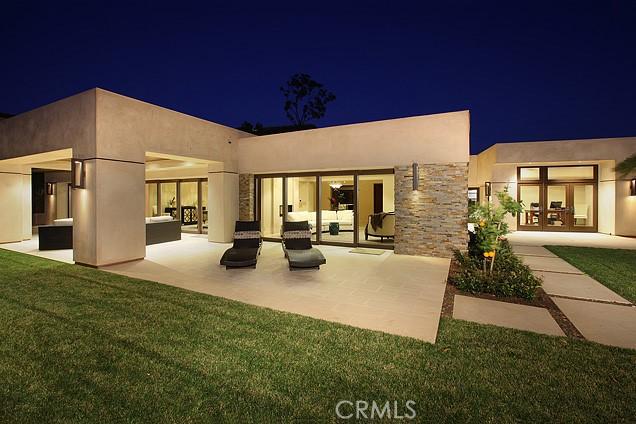 32661 Caribbean Dr, Dana Point, CA 92629 - back of house at twilight featuring stucco siding, a yard, a patio area, and outdoor lounge area