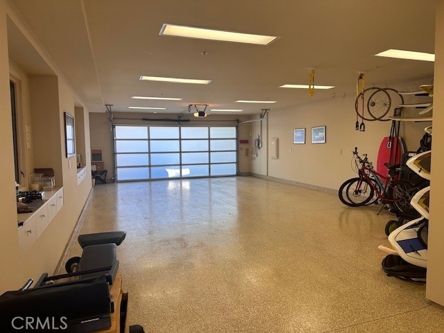 32661 Caribbean Dr, Dana Point, CA 92629 - garage featuring baseboards and a garage door opener