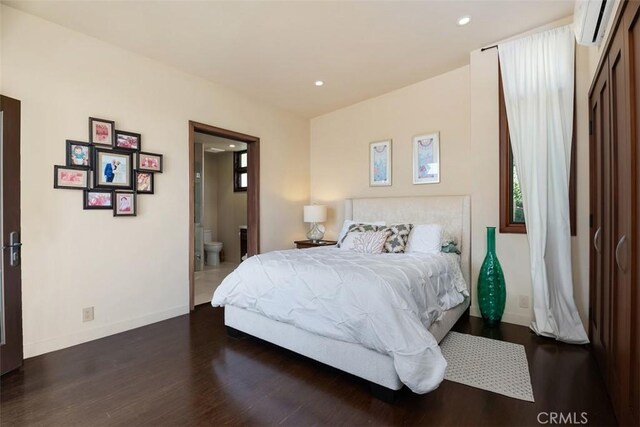 32661 Caribbean Dr, Dana Point, CA 92629 - bedroom with a wall unit AC, wood finished floors, recessed lighting, and ensuite bathroom