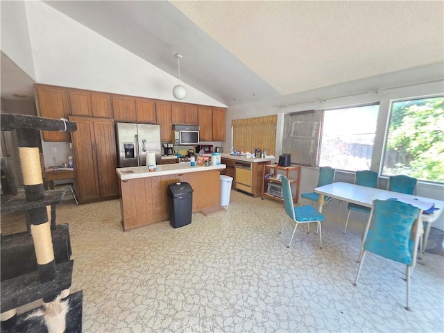 2108 Ardenwood Ave, Simi Valley, CA 93063 - kitchen with appliances with stainless steel finishes, lofted ceiling, light countertops, a kitchen island, and brown cabinets
