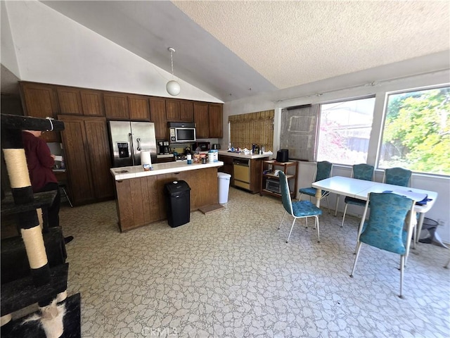 2108 Ardenwood Ave, Simi Valley, CA 93063 - kitchen featuring appliances with stainless steel finishes, vaulted ceiling, a center island, light countertops, and a textured ceiling