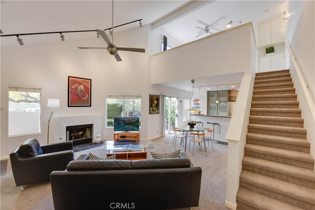 796 Via Colinas, Thousand Oaks, CA 91362 - carpeted living area with a ceiling fan, rail lighting, stairway, and high vaulted ceiling