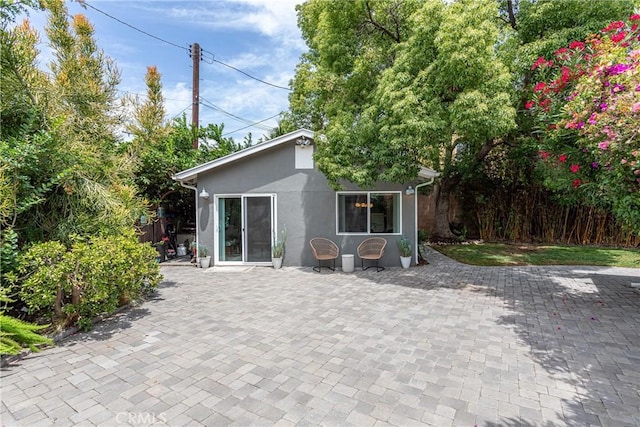 16733 Archwood St, Van Nuys, CA 91406 - rear view of house featuring stucco siding and a patio area