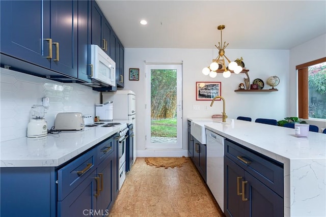 16733 Archwood St, Van Nuys, CA 91406 - kitchen featuring blue cabinetry, a peninsula, white appliances, a sink, and recessed lighting