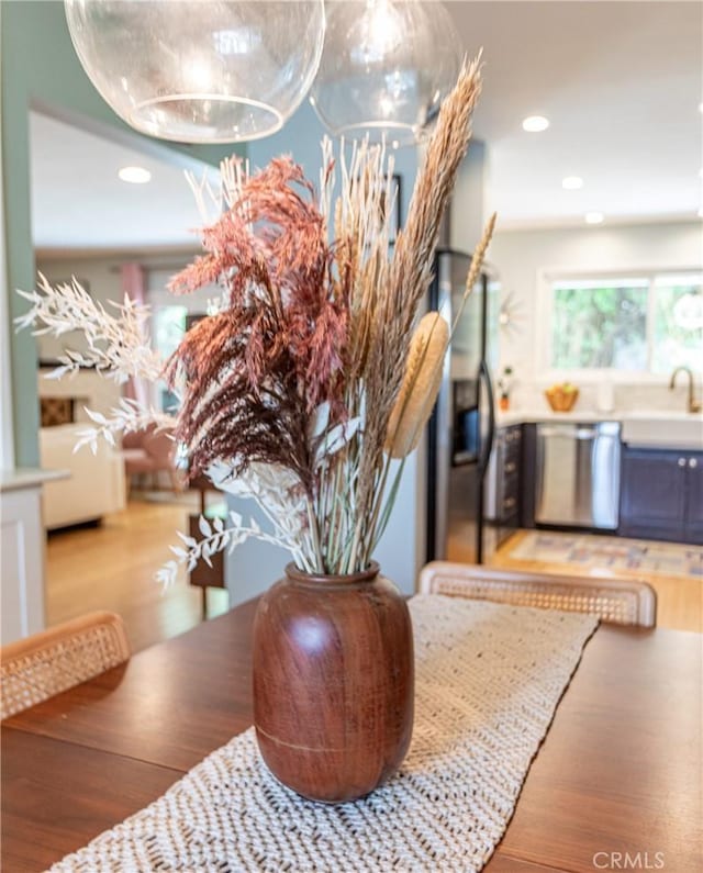 16733 Archwood St, Van Nuys, CA 91406 - dining area view of stainless steel appliances, wood finished floors, a sink, and recessed lighting
