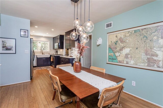 16733 Archwood St, Van Nuys, CA 91406 - dining room featuring light wood-style floors, baseboards, and recessed lighting